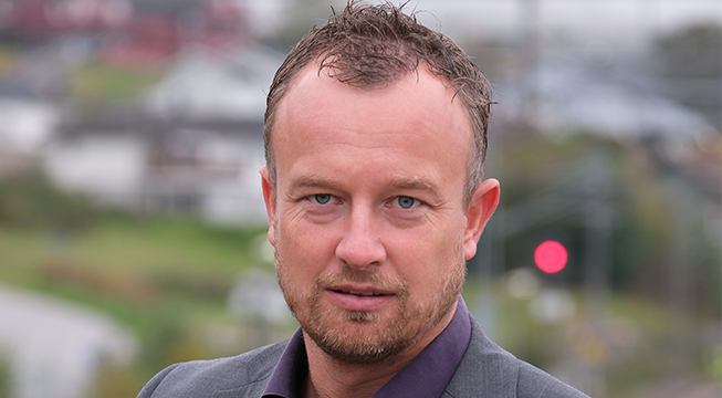 Portrett av fylkesordfører Sven Tore Løkslid, avbildet fra brysthøyde og opp, ser alvorlig rett i kamera.